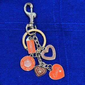 Orange and Gold Heart Charm Keychain. Charm says “Coach”